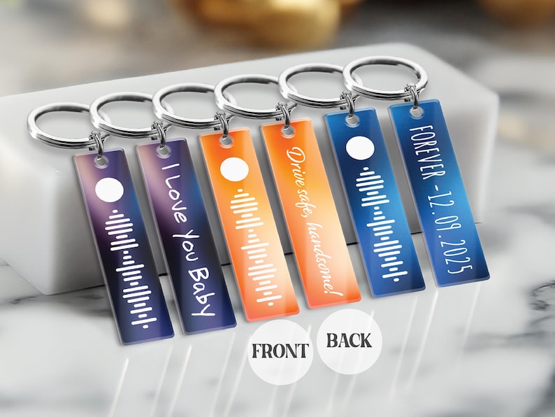 May include: Five colorful keychains with a barcode and text on each. The keychains are made of acrylic and have a silver metal ring. The text on the keychains reads: "FOREVER - 12.09.2025", "Drive safe, handsome!", "I Love You Baby", and two keychains with a barcode only.