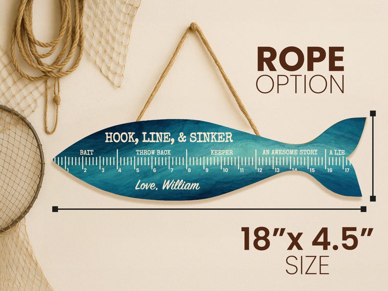 May include: A fish-shaped wooden wall sign with a blue watercolour texture, hanging by a rope. It features a ruler from 1 to 17 inches, the text "HOOK, LINE, & SINKER", "Love, William", and fishing labels. The sign measures 45.7 cm by 11.4 cm.