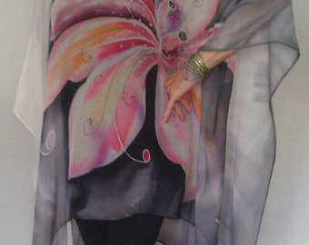 May include: A sheer, gray and white silk top with a large, pink and orange floral design. The top has a loose, flowing fit and a scoop neckline.