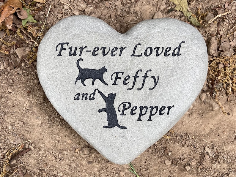 Heart shaped pet memorial stone with cats.