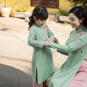 Women and kid matching Ao dai- Vietnamese traditional dress