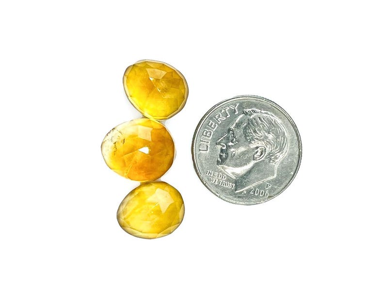 Three yellow citrine gemstone cabochons size 11 to 12 mm.  Rose cut cabochon stones seen next to a dime for size reference.