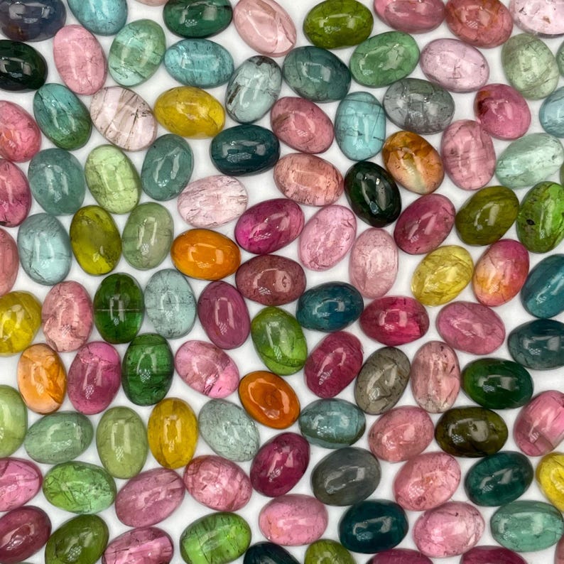 Multiple tourmaline gemstone cabochons size 7 x 5 mm.  Multi-colored smooth cut oval cabochon stones.