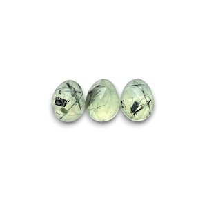 Tourmalinated prehnite gemstone cabochons.  Three rose cut cabochon stones seen from the top.