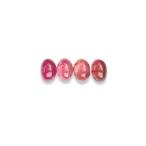 Pink tourmaline gemstone cabochons.  Four smooth cut oval cabochon stones size 7 x 5 mm seen from the top.
