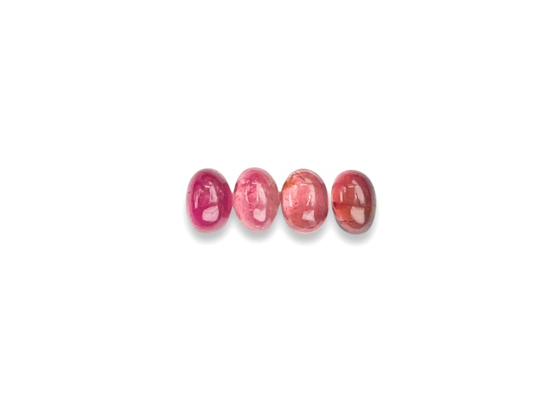 Pink tourmaline gemstone cabochons.  Four smooth cut oval cabochon stones size 7 x 5 mm seen from the top.
