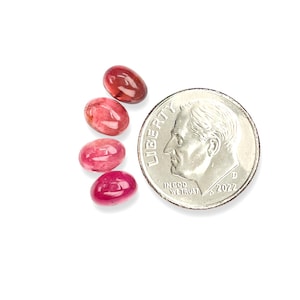 Pink tourmaline smooth cut oval cabochon stones.  Four gemstone cabochons size 7 x 5 mm pictured next to a dime for size reference.
