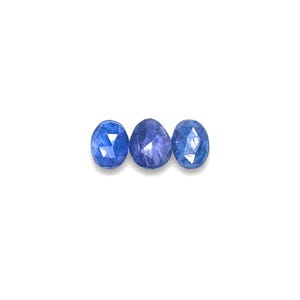Blue tanzanite gemstone cabochons.  Three rose cut cabochon stones size 7.5 to 8.5 mm seen from the top.