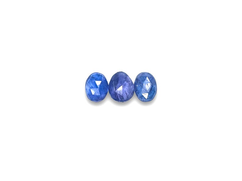 Blue tanzanite gemstone cabochons.  Three rose cut cabochon stones size 7.5 to 8.5 mm seen from the top.