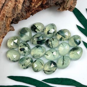 Multiple tourmalinated prehnite rose cut cabochon stones.  Gemstone cabochons size 9.5 - 11 mm.