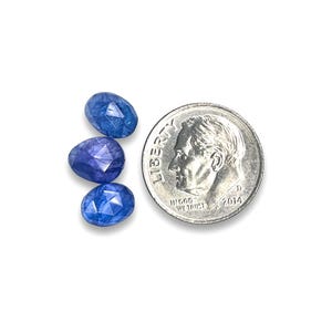 Three blue tanzanite rose cut cabochon stones.  Gemstone cabochons size 7.5 to 8.5 mm pictured next to a dime for size reference.