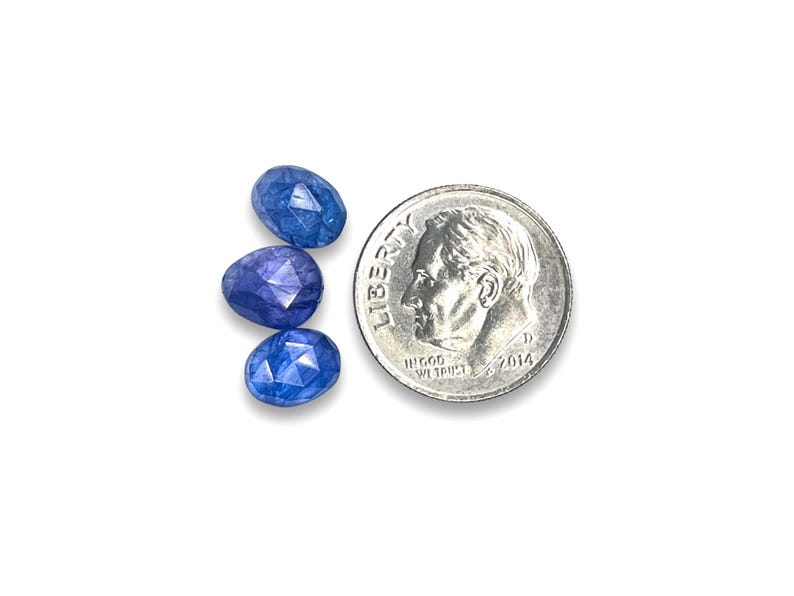 Three blue tanzanite rose cut cabochon stones.  Gemstone cabochons size 7.5 to 8.5 mm pictured next to a dime for size reference.