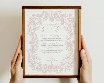 May include: A framed print featuring a prayer for "Gemma Rose", with a floral wreath design in a soft pink colour. The wooden frame adds a classic touch. The text includes the date "October 15, 2025". The print is a thoughtful gift. The frame measures approximately 20 cm.