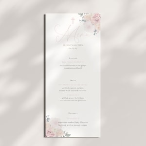 May include: A baptism menu card with a delicate floral design. The card features a cross and the word "Menu" in script. The menu includes starters, main courses, and desserts. The card is decorated with a floral arrangement in the upper right corner.