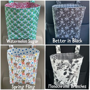 May include: Four fabric car trash bags in various patterns. One is teal with white flowers, labeled "Watermelon Sugar." Another is black floral, labeled "Better in Black." A third is floral with bicycles, labeled "Spring Fling." The last is black and white branches, labeled "Monochrome Branches."