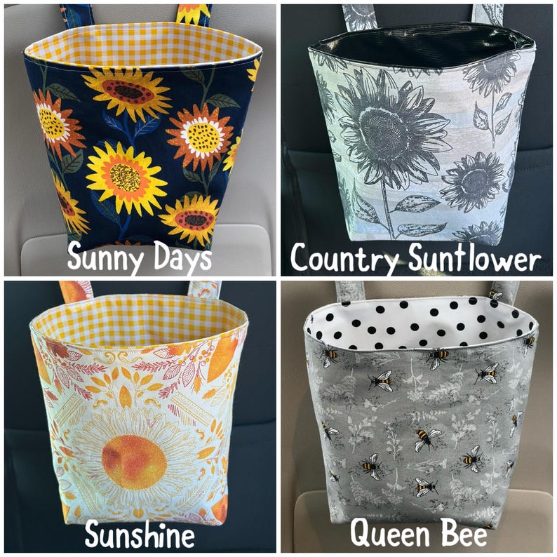 May include: Four fabric car trash bags with different patterns. One bag has sunflowers on a navy background, another has gray sunflowers, a third has a large sunflower design, and the last has bees. Each bag has a contrasting interior and hanging straps.