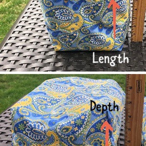 May include: A fabric storage basket with a blue and yellow paisley pattern. The basket is 9 inches long, 11 inches wide, and 4.5 inches deep. The interior is a solid navy blue.