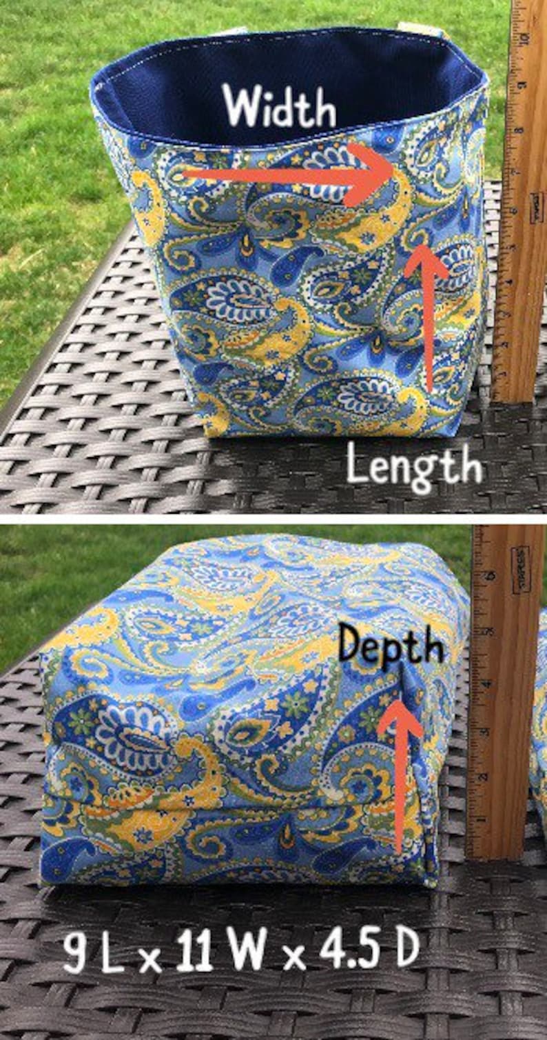May include: A fabric storage basket with a blue and yellow paisley pattern. The basket is 9 inches long, 11 inches wide, and 4.5 inches deep. The interior is a solid navy blue.