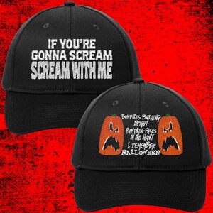 May include: Two black baseball caps with white embroidered text. One cap says "If you're gonna scream scream with me". The other cap says "Bonfires burning bright pumpkin-faces in the night I remember Halloween".