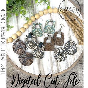 May include: A set of six wooden earrings with intricate laser-cut designs. The earrings are in various shapes, including circles and squares, and feature a mix of brown, black, and white colors. The earrings are displayed on a wooden tray with a white background. The text "Digital Cut File" is written in black cursive on the bottom of the image.