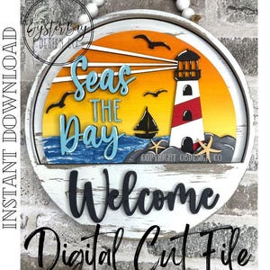 May include: Round wooden sign with a lighthouse, sailboat, and seagulls against an orange and yellow sunset. The sign says "Seas the Day" and "Welcome". The words "Digital Cut File" are also displayed.