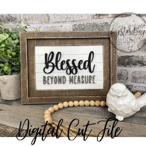 May include: A wooden sign with the text "Blessed Beyond Measure" in black lettering on a white background. The sign is framed in a rustic brown wood frame and is sitting on a wooden surface with a white bird figurine and a string of wooden beads.