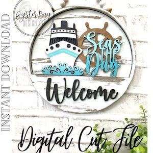 May include: A white wooden round sign with a blue and white ship, a brown wooden steering wheel, and the text "Seas the Day" in blue. The sign also has the word "Welcome" in black.