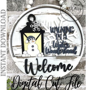 May include: A white wooden round sign with a black and white snowman, a black lantern, and a white snowflake with the text "Walking in a Winter Wonderland" and "Welcome" in black lettering.
