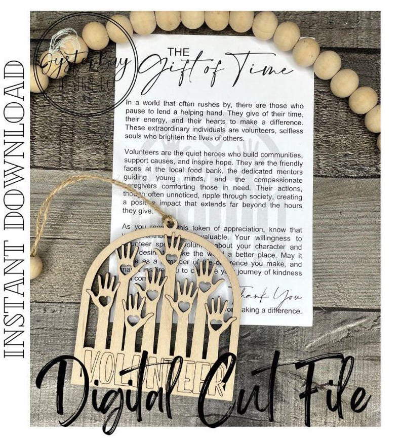 May include: A wooden cutout of a hand with the word "Volunteer" written below it. The cutout is in the shape of a half circle and has several hands reaching up with hearts in their palms. The cutout is on a white background with a text card that reads "The Gift of Time".