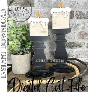 May include: Two black wooden candle holders with white candle cutouts. The candles have a distressed wood look and are topped with a small yellow flame. The candle holders are sitting on a wooden tray with white beads.