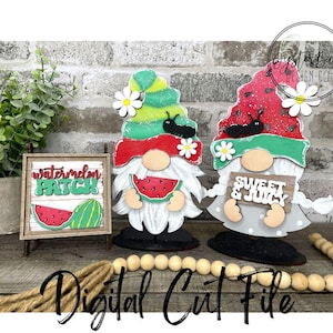 May include: Wooden watermelon-themed gnomes with white beards, holding watermelon slices. One gnome has a sign that says "Sweet & Juicy". A small wooden sign says "Watermelon Patch". The gnomes have red, green, and white accents.