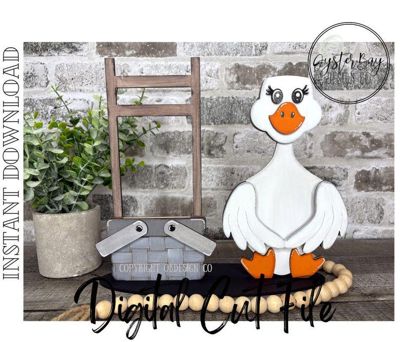 May include: A wooden goose figurine with a white body, orange beak and feet, and decorative eyelashes. A gray picnic basket and a small wooden ladder are also present. The words "Instant Download" and "Digital Cut File" are visible.