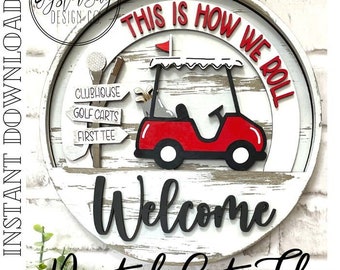 May include: A round wooden sign with a red golf cart, white and red text that says "This is how we roll", and black text that says "Welcome". The sign also has three white signs that say "Clubhouse", "Golf Carts", and "First Tee".