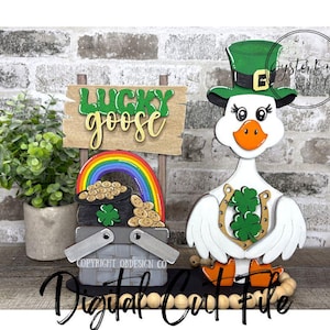 May include: A wooden St. Patrick's Day decoration featuring a white goose wearing a green leprechaun hat and holding a horseshoe with a shamrock. A sign that says "Lucky Goose" and a rainbow with a pot of gold are also included.