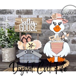 May include: A wooden beach-themed decoration featuring a goose wearing a hat and holding a bucket with a starfish and a pinwheel. A sign reads "Salty Goose" above a basket with seashells and flip-flops. The words "Digital Cut File" are at the bottom.