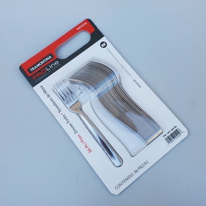 May include: A package of 36 stainless steel dinner forks. The package is white with red and black text. The text on the package reads "Tramontina ProLine Commercial Grade 36 pc/pzas Dinner Forks Tenedores de Mesa  Contenido: 36 Piezas ITM/ART 800108 #800108 Windsor - Stainless Steel Acero Inoxidable NSF".