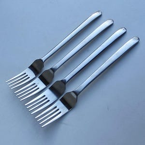 May include: A set of three ceramic mugs with a speckled, matte finish. Each mug features a different color: light blue, cream, and gray. The mugs have a simple, modern design and a comfortable handle. Perfect for coffee or tea.