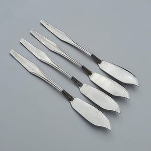 May include: Set of five silver butter knives with ornate handles.