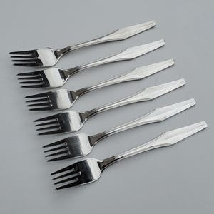 May include: Six silver forks with a beaded design on the handle. The forks are arranged in a row, with the tines pointing towards the top of the image.
