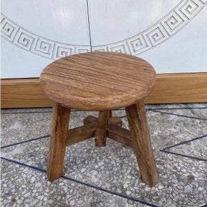 Round Chinese stool from reclaimed elm wood door more than 60 years