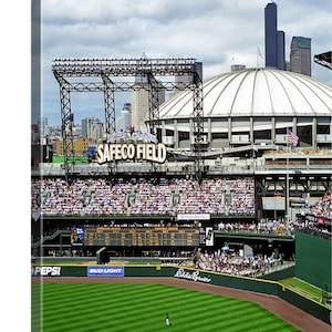 May include: A view of Safeco Field, home of the Seattle Mariners baseball team. The stadium is filled with fans, and the field is green. The scoreboard shows the score of the game. The stadium is located in Seattle, Washington.