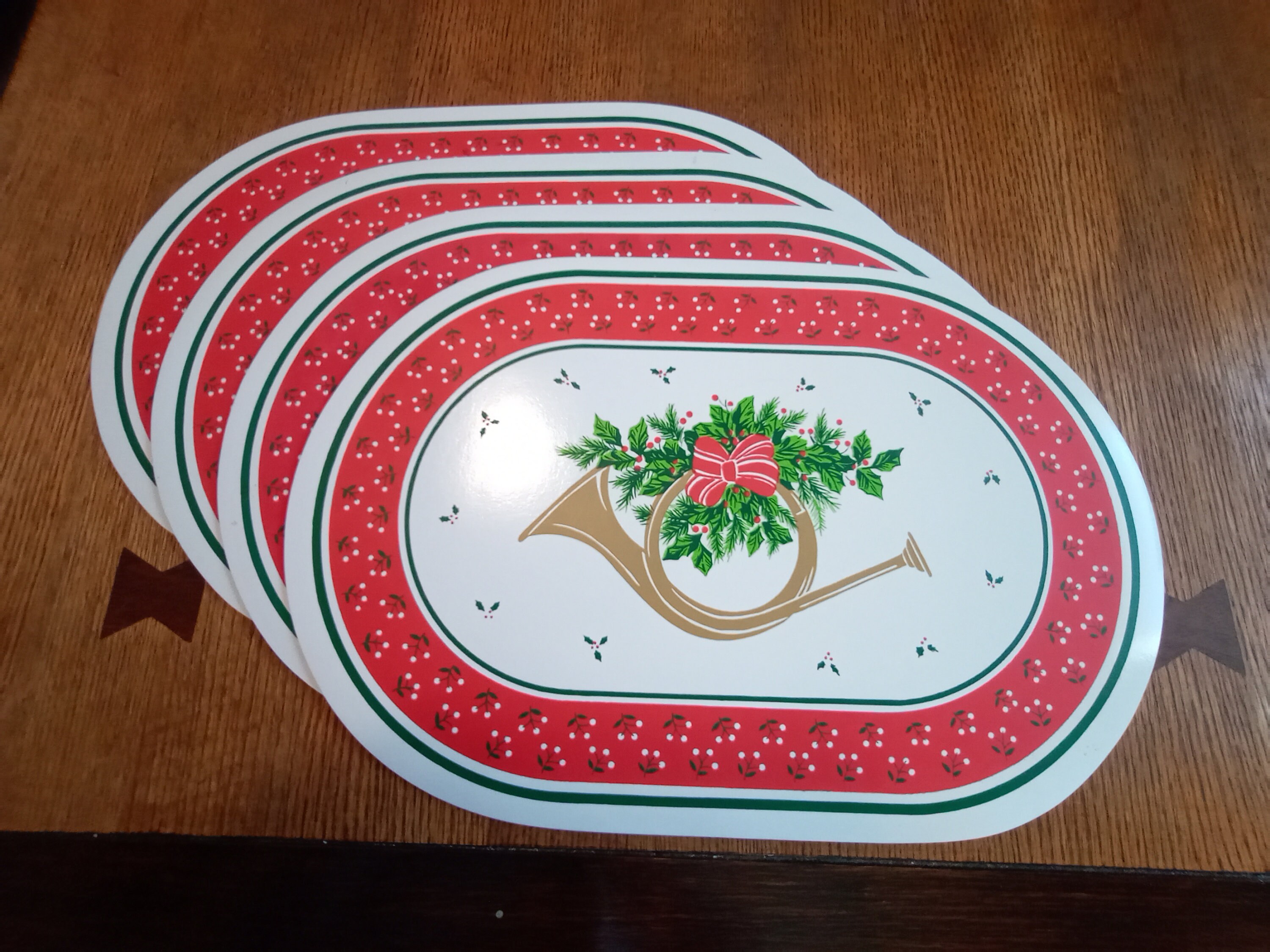 3 Sets of Washable Vinyl Holiday Placemats, Holly, Trumpets, Bells