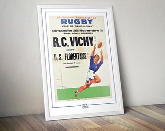 May include: A vintage poster advertising a rugby match between R.C. Vichy and U.S. Florentaise on November 22, 1953 at Stade Albert Soubiran in Saint-Florent. The poster features a player in a blue jersey catching a rugby ball.
