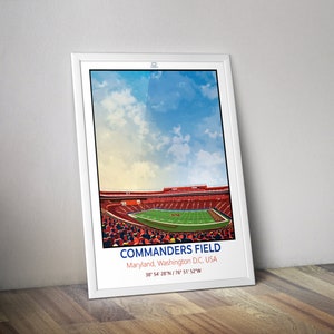 May include: A digital illustration of Commanders Field, a football stadium in Landover, Maryland. The stadium is shown with a green pitch, red seats, and a blue sky with white clouds. The text "COMMANDERS FIELD" is displayed in blue and white letters, along with the location "Maryland, Washington D.C., USA" and the coordinates "38° 54' 28"N/76° 51' 52"W".