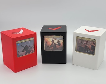 May include: Three different colored card boxes with a red, white, and black color scheme. Each box has a small window to display a card. The top of each box has a red V-shaped logo.