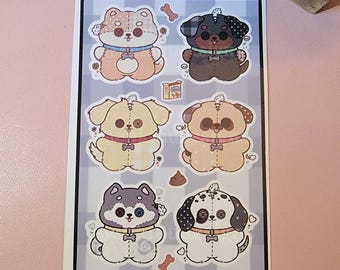 May include: A sticker sheet with six cartoon dog designs. Each dog has a unique colour and pattern, with button details and a small bone or treat graphic. The background is a grey and white chequered pattern.