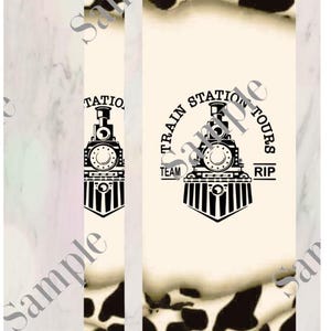 May include: A black and white pen with a cow print design. The pen has a black cap and a silver clip. The pen is decorated with a black and white train logo that says "Train Station Tours" with the words "Team" and "RIP" on either side of the logo.