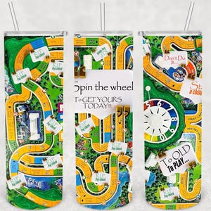 May include: Three stainless steel tumblers with a design inspired by the game Monopoly. The tumblers feature a green, yellow, and blue background with the Monopoly board game design. The tumblers have a white rim and a clear lid. The text on the tumblers reads "Spin the wheel to get yours today!" and "Too old to play..."