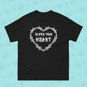 May include: Black t-shirt with a white barbed wire heart design and the text "Bless Your Heart" inside the heart.