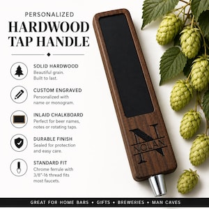 May include: A rectangular dark wood beer tap handle featuring an inlaid black chalkboard panel and a custom engraved letter N with the name NOLAN. The handle includes a chrome ferrule with a 3/8-16 thread and is displayed next to green hops.